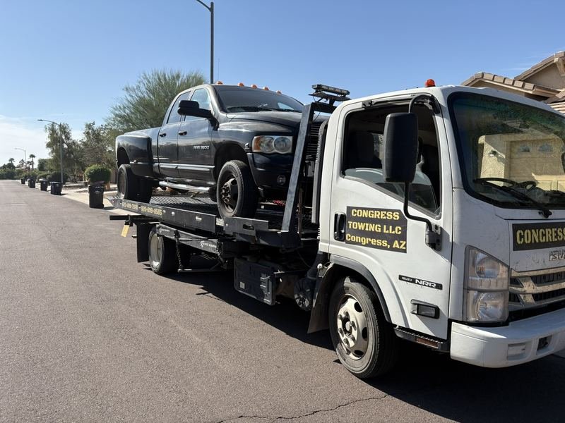 Dually pickup towed from a neighborhood street